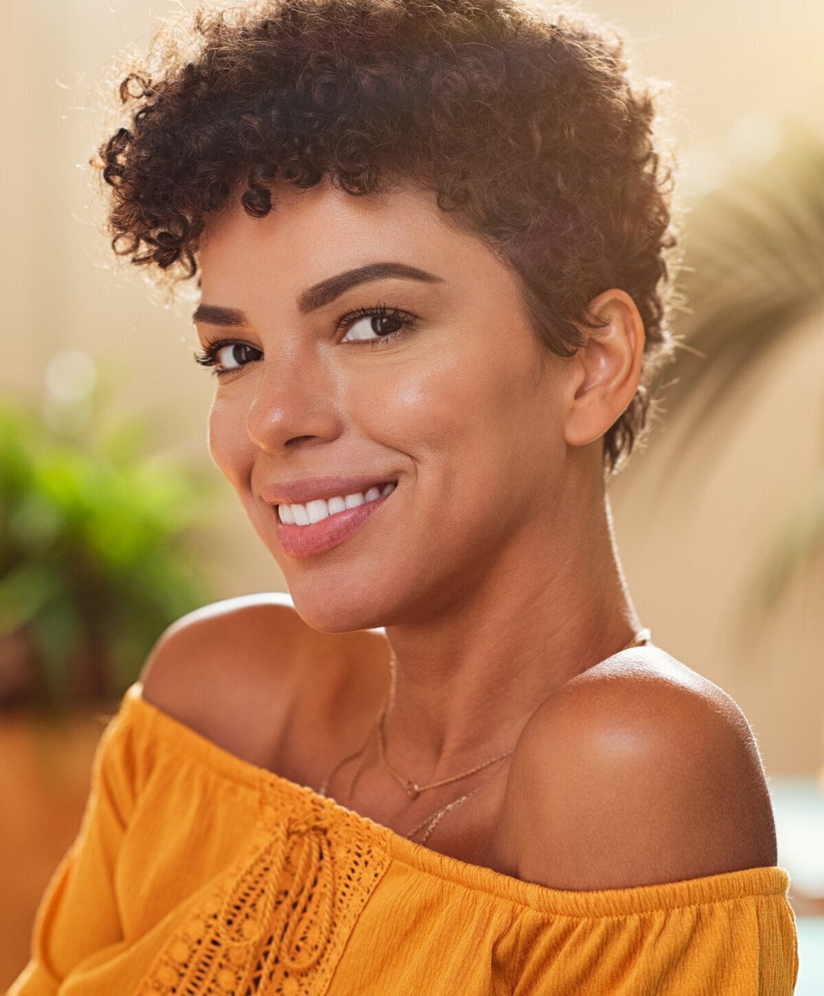 houston vitamin injection model smiling with short curly hair